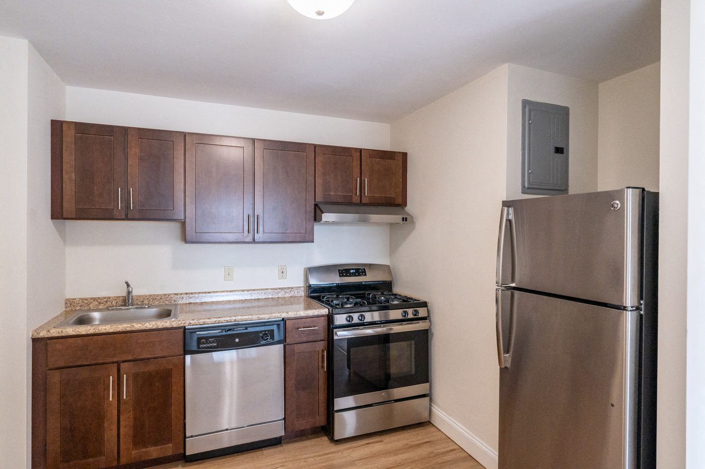 a kitchen with stainless steel appliances and wooden cabinets